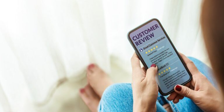 Customer Experience and Online Review Concept. Female sitting in house to Reading Customer Review in SmartPhone before Buying Products. Top view